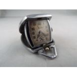 An Art Deco styled cushion form purse watch/ clock, the case with engine turned decoration,