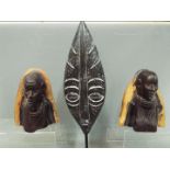 A pair of African tribal carved busts depicting a male and a female figure,