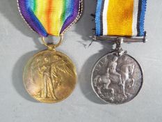 A WWI medal pair comprising Victory Medal and British War Medal, named to 200271 A. SJT. H. ACKROYD.