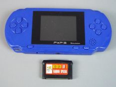 Gaming - a PXP 3 hand-held games console with a games compendium disk