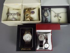 A collection of boxed fashion watches.