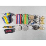 A WWII medal pair comprising Defence Medal and War Medal 1939-1945 along with a Silver War Badge,