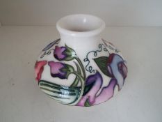 Moorcroft Pottery - a squat vase decorated in the 'Sweetness' pattern, 7.