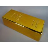A novelty door stop in the form of a gold bar