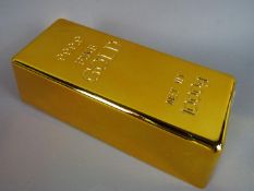 A novelty door stop in the form of a gold bar