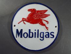 A cast iron Mobil sign.