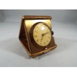 A yellow metal purse watch/ small travelling clock,