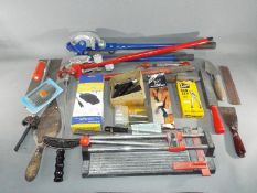 Two sets of pipe benders with a quantity of hand tools including a tile cutter, trowel, float,