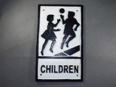 A cast 'Children' sign. (ychil).