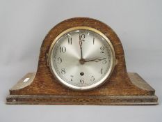 A Napoleons hat mantel clock, Arabic numerals to the dial, movement marked '14 Day British Made',