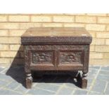 An antique storage chest highly carved with hinged lid 44 cm x 55 cm x 44 cm