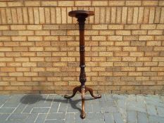 A good quality plant stand on tripod supports,