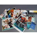 A collection of James Bond related items to include posters, books and similar.
