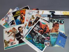 A collection of James Bond related items to include posters, books and similar.