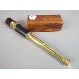 A boxed brass and leather telescope