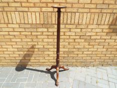 A good quality plant stand on tripod supports having ball and claw feet and fluted column with