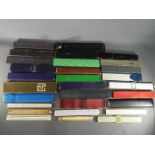 A large collection of various slide rules, different makes and models, in excess of 25 examples.