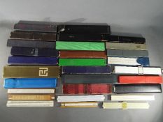 A large collection of various slide rules, different makes and models, in excess of 25 examples.