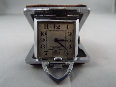 A small purse watch/ clock in a 36mm square cushion form case with brown shagreen or leather