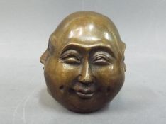 A small brass sculpture depicting a four-faced Budha,