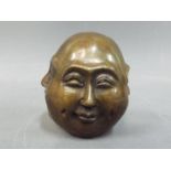 A small brass sculpture depicting a four-faced Budha,