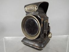 A Joseph Lucas Ltd, Birmingham, 'Warna' oil powered motorcycle / bicycle lamp with red lens.