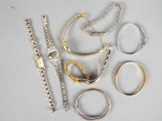 A collection of wristwatches and three bangles.