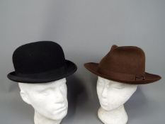 Two vintage hats comprising a Harrods of London bowler hat (approximately 59 cm internal