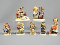 Hummel - Seven Hummel figurines including The Photographer, The Builder, Apple Tree Boy and similar.