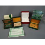 Three vintage Rolex watch boxes, two with outer card boxes, and a Cartier watch box.