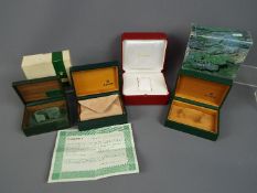 Three vintage Rolex watch boxes, two with outer card boxes, and a Cartier watch box.