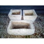 A matched pair of reconstituted stone square planters and a rectangular stone planter (3)