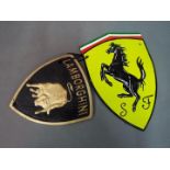 Two cast iron wall plaques, one marked Ferrari the other Lamborghini.