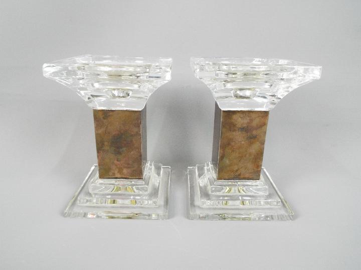 A pair of Mappin & Webb silver and glass candlesticks with stepped base,