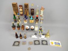A lot to include various miniatures, commemorative crowns, cast iron figures and similar.