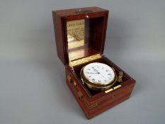 A Relide boxed ships gimbal chronometer.