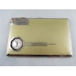 An Art Deco cigarette case or card holder with integral watch and lighter,