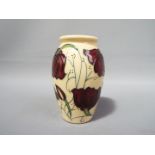 Moorcroft - a Moorcroft vase in the Chocolate Cosmos pattern, approximate height 10.