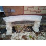 A reconstituted stone garden bench decorated with squirrel supports
