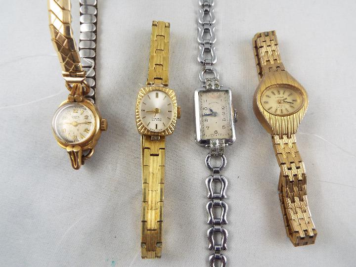 A collection of four lady's wristwatches