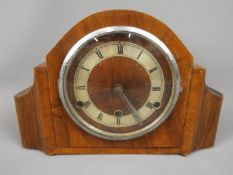 A wood cased mantel clock with Roman num