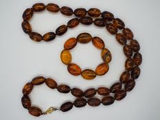 An amber bead necklace consisting of 40 oblong beads approximately 20 mm x 14 mm,