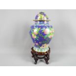 A large Chinese cloisonné enamel vase and cover decorated with branches of peach,