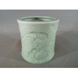 A Chinese or Japanese celadon glaze brush pot of slightly waisted form,