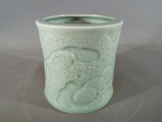 A Chinese or Japanese celadon glaze brush pot of slightly waisted form,