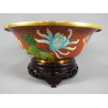 A large Chinese cloisonné enamel footed bowl decorated to the interior and exterior with flowering