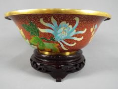 A large Chinese cloisonné enamel footed bowl decorated to the interior and exterior with flowering