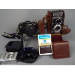 Photography - A vintage Rolleicord camera with leather case, a Praktica BC1,
