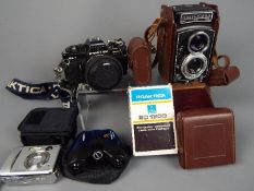 Photography - A vintage Rolleicord camera with leather case, a Praktica BC1,
