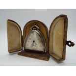 A small Art Deco silver purse or desk watch/ clock in the style of a horse’s stirrup,